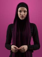 Modern Muslim woman wearing stylish hijab casual wear isolated on pink background. Diverse people model hijab fashion concept. photo