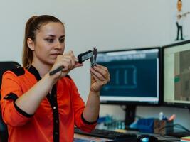 Within the heavy industry, a factory industrial engineer measures with a caliper and on a personal computer Designs a 3D model photo