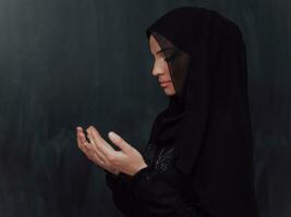 Portrait of young Muslim woman making dua photo