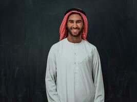 Portrait of young muslim man wearing traditional clothes photo