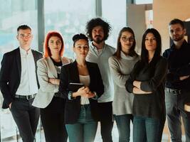 Young Smiling Managers Standing in Modern Office. Training in Office. Modern Office Concept. Woman in White Shirt. Man in Black Suit. photo