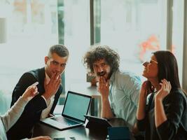 a crazy portrait of a group of entrepreneurs sitting in a modern office. photo