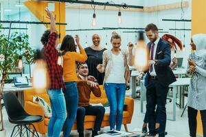 Group of business people throwing paper in air at modern startup office, team success and job done concept photo