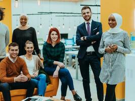 Multiethnic group of employees working in a marketing company. A group of colleagues is working on a project in modern offices photo