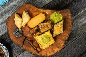 eid Mubarak tradicional Ramadán iftar cena. clasificado sabroso comida en auténtico rústico platos en de madera azul antecedentes. turco bosnio comida carne brocheta, Agave, sarma, klepe, sogan dolma. foto