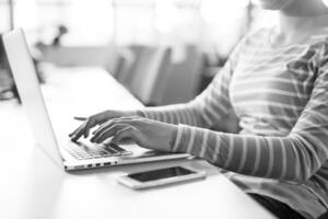 businesswoman using a laptop in startup office photo