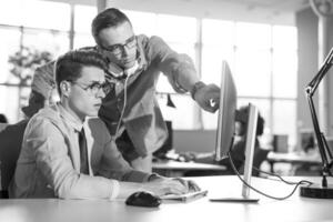 Two Business People Working With computer in office photo