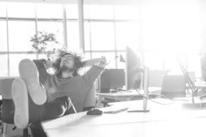 businessman sitting with legs on desk photo