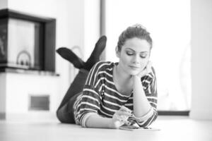 woman using tablet computer in front of fireplace photo