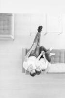 Young couple on the sofa watching television top view photo