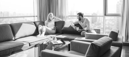 couple relaxing at  home using tablet computer photo