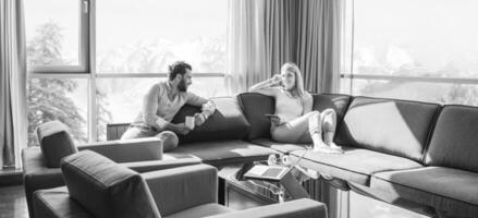 couple relaxing at  home using tablet computer photo