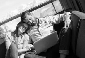 couple relaxing at  home using laptop computers photo