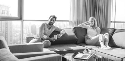 couple relaxing at  home using tablet computer photo