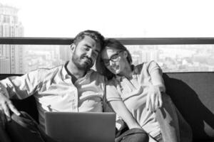 couple relaxing at  home using laptop computers photo