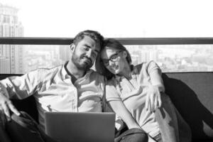 couple relaxing at  home using laptop computers photo