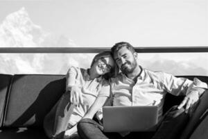 couple relaxing at  home using laptop computers photo