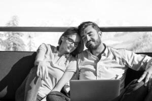 couple relaxing at  home using laptop computers photo