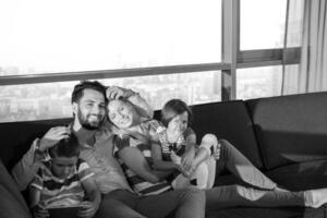 happy young couple spending time with kids at home photo