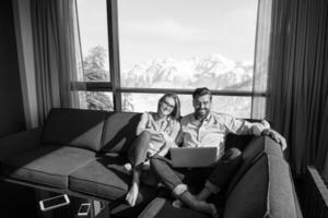 couple relaxing at  home using laptop computers photo