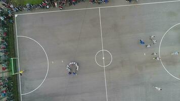 top view drone flying above amateur soccer game match. Countryside authentic tournament. photo