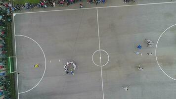 top view drone flying above amateur soccer game match. Countryside authentic tournament. photo