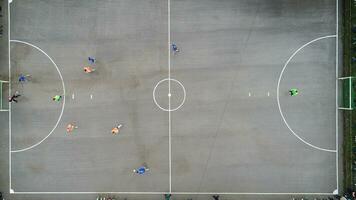 top view drone flying above amateur soccer game match. Countryside authentic tournament. photo