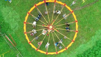 Carnival Merry Go Round aerial top view. Drone tracking rotation shoot. photo