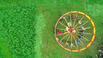 Carnival Merry Go Round aerial top view. Drone tracking rotation shoot. photo