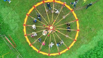 Carnival Merry Go Round aerial top view. Drone tracking rotation shoot. photo