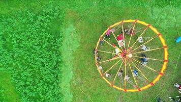 Carnival Merry Go Round aerial top view. Drone tracking rotation shoot. photo