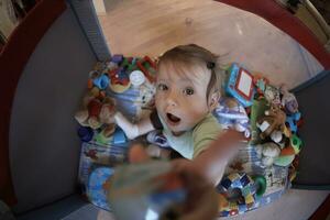 cute  little  baby playing in mobile  bed photo