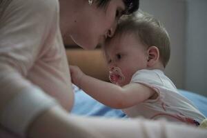 mother is playing with baby at home photo