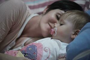 mother is playing with baby at home photo