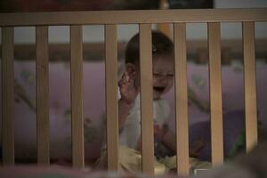 cute  little one year old baby and making first steps in bed photo