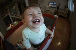 cute  little  baby playing in mobile  bed photo