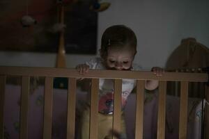 cute  little one year old baby and making first steps in bed photo