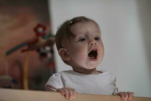 cute  little one year old baby and making first steps in bed photo