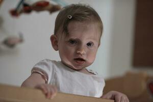 cute  little one year old baby and making first steps in bed photo