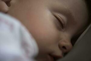 newborn baby sleeping  at home in bed photo