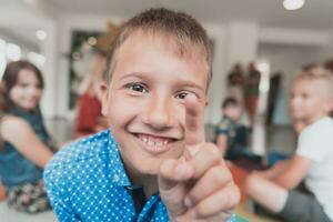 Portrait photo of a smiling boy in a preschool institution having fun