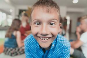 retrato foto de un sonriente chico en un preescolar institución teniendo divertido
