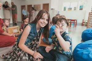 A girl and a boy with Down's syndrome in each other's arms spend time together in a preschool institution photo