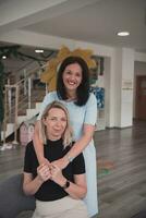 Portrait of two hugging female teachers in a preschool institution, in the background of the classrooms photo