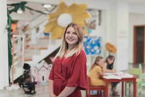 Portrait of a teacher in a preschool institution, in the background of the classrooms photo