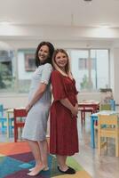 Portrait of a two teacher in a preschool institution, in the background of the classrooms photo