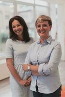 Portrait of a two teacher in a preschool institution, in the background of the classrooms photo