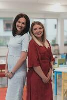 Portrait of a two teacher in a preschool institution, in the background of the classrooms photo