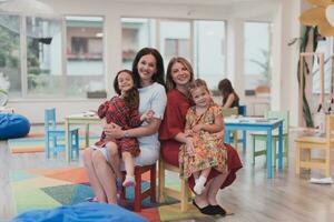 A child hugging a teacher in a modern kindergarten photo