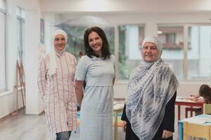 Portrait of a three teachers in a preschool institution, in the background of the classrooms photo